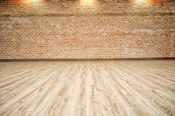 istock BRICK WALL WITH WOOD FLOOR BACKGROUND 591824230