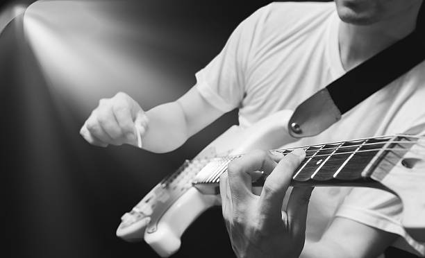 istock asian musician playing electric guitar on stage 591826374