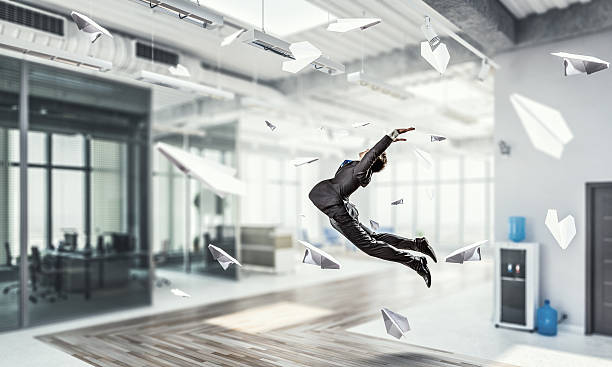 istock Jumping businessman in office . Mixed media 591827818