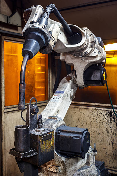 istock Welding robots movement in a car factory 591829210