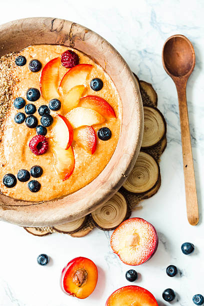 istock smoothie bowl with peaches, plums and blueberries 591829588