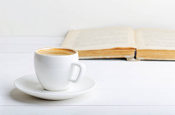 istock Cup of espresso and book 591829740
