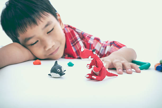 istock Asian child show his works from clay, on white background. 591830186