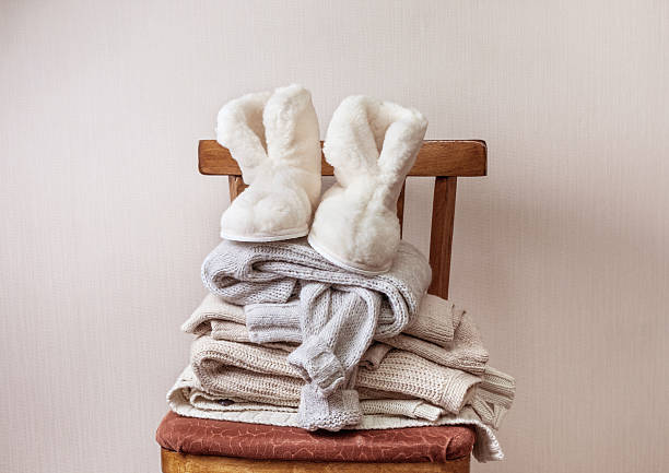 istock sheepskin slippers, stack of warm clothes 591830466