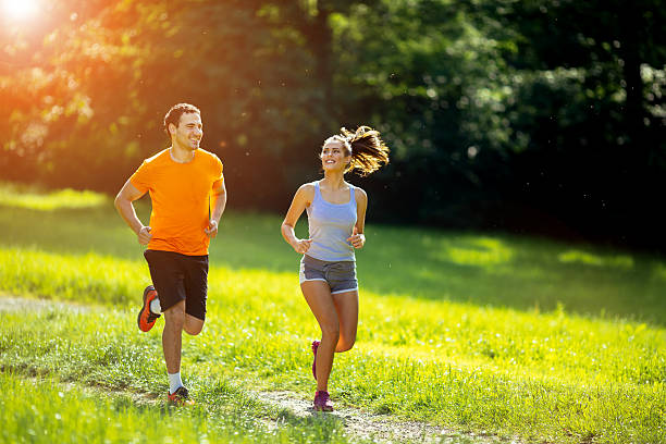 istock Athletic couple jogging in nature 591832674