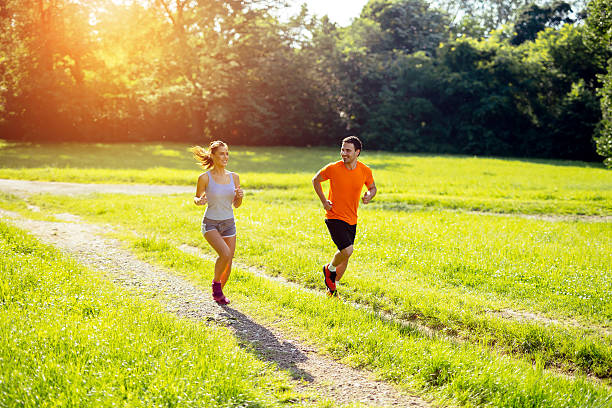 istock Athletic couple jogging in nature 591833158