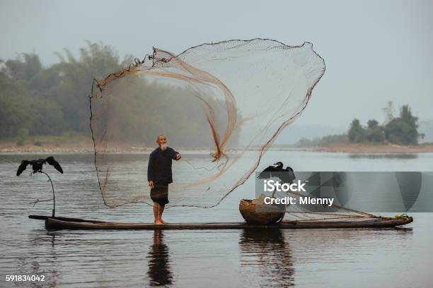 Chinese Traditional Senior Fisherman Throwing Fishing Net Li River China Stock Photo - Download Image Now