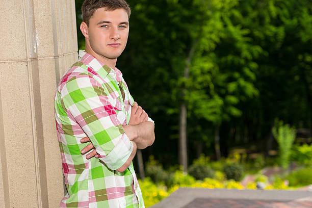 istock Pensive young man standing near wall in a forest 591834984