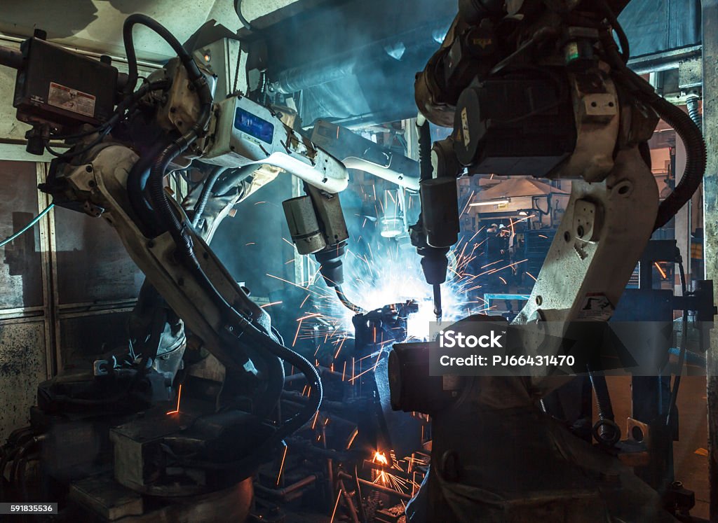 Robots welding industry Welding robots movement in a car factory Robotic Arm Stock Photo