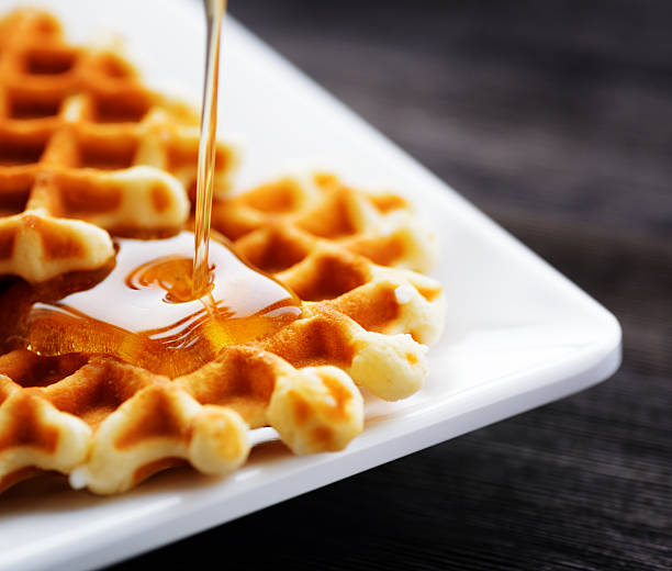 istock Honey pouring on a fresh waffles 591836878