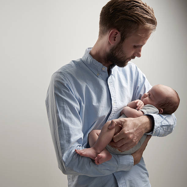 istock Proud parent watching his newborn son 591837612