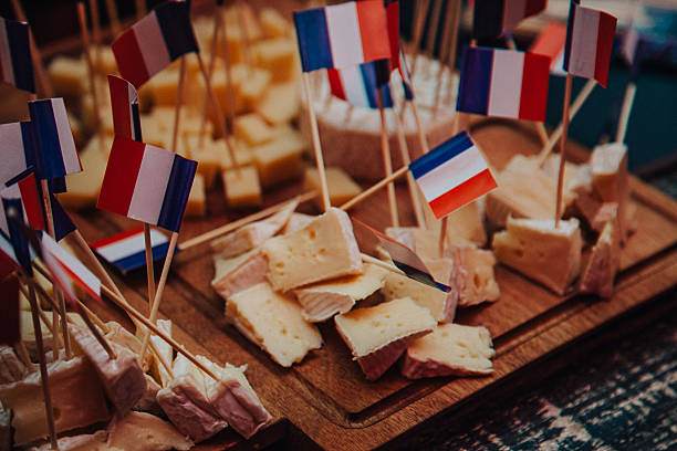 French cheeses with France flag French style cheese with France flag ornate on market stall hoofed mammal stock pictures, royalty-free photos & images