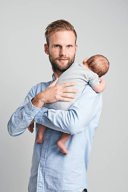 istock Proud parent watching his newborn son 591838092