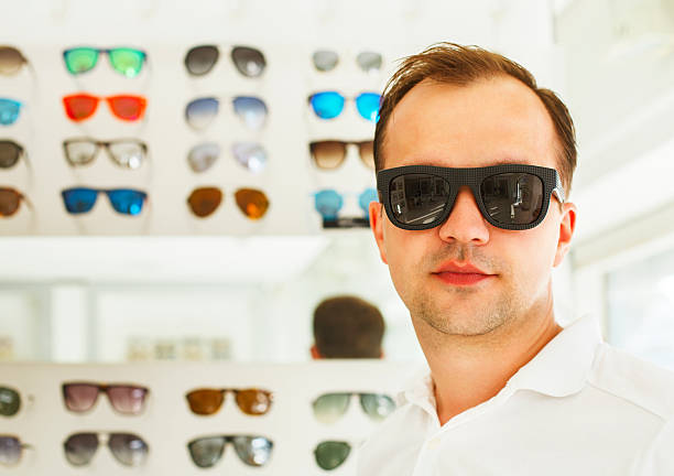 istock Man trying on new sunglasses at the opticians 591839052