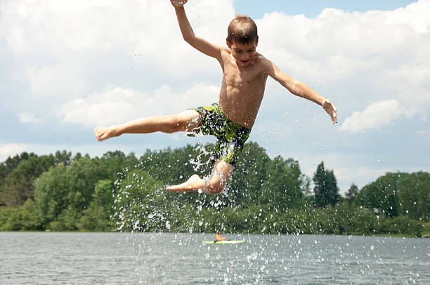 istock Young boy being thrown into a lake in Canada 591839234