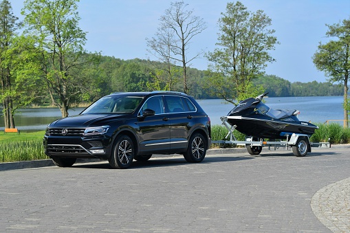 Olsztyn, Poland - May 12th, 2016: The presentation of a second generation of Volkswagen Tiguan with trailer and jet ski. This model is one of the most popular sport utility vehicles in Europe.