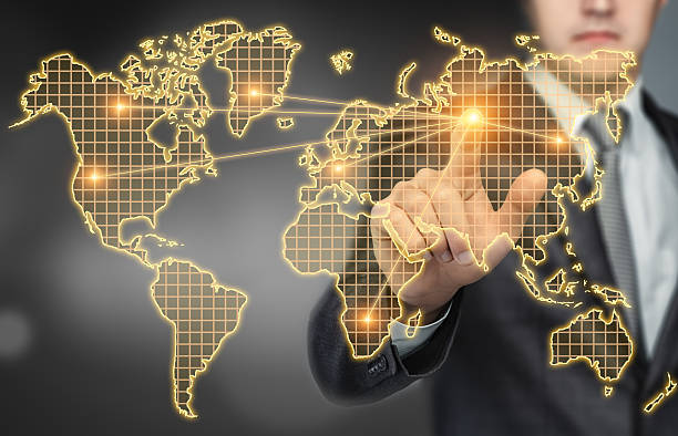 istock Businessman touching the world map digital touchscreen with his finger 591842682