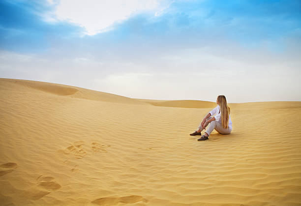 Beauty blond woman in desert. Sahara desert Beauty blond woman in desert. Sahara desert - Douz, Tunisia. tunisia sahara douz stock pictures, royalty-free photos & images