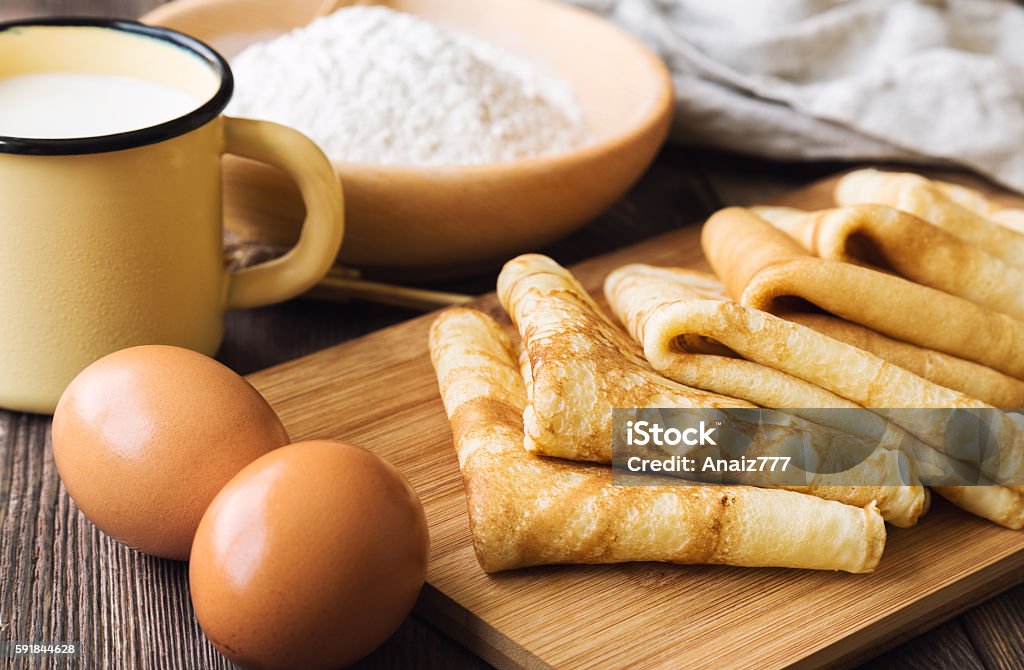 Fresh homemade crepes with ingredients Fresh homemade crepes with ingredients on rustic wooden background. Crêpe - Pancake Stock Photo