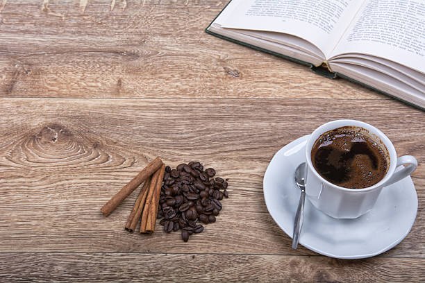 istock cup of coffee and cinnamon with a book 591844894