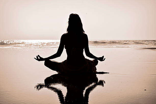 istock Young woman meditating 591845650