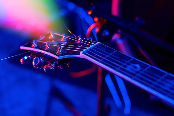 Guitar at the concert in colorful light.