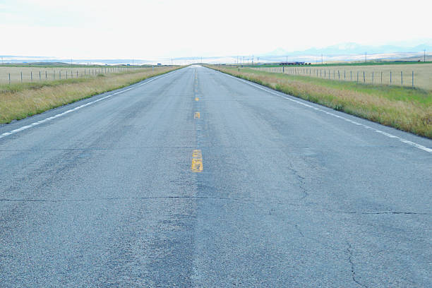 istock Open road through grasslands in Montana. 591846662
