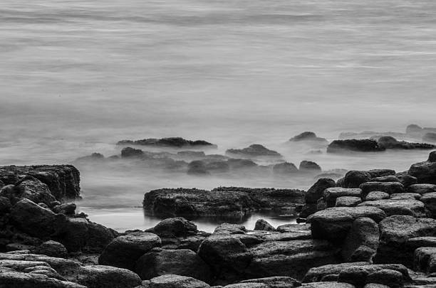 istock Lava Rocks in Ocean Waves 591849032