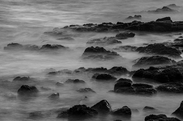 istock Lava Rocks in Ocean Waves 591849066