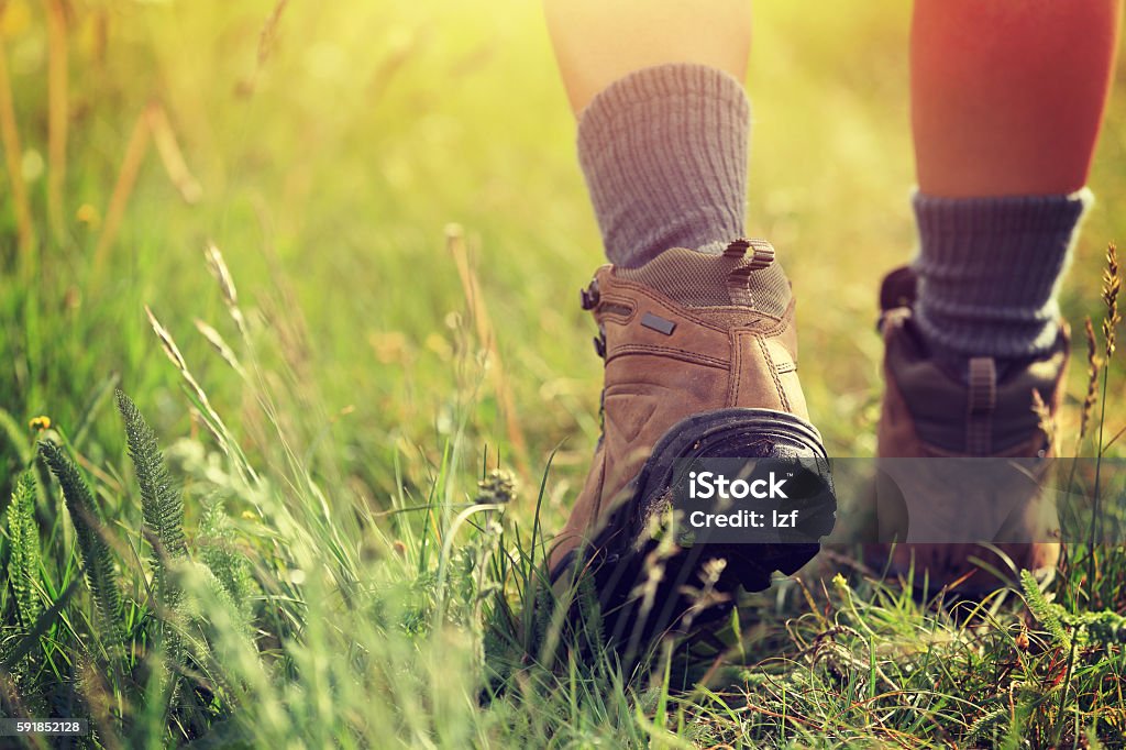 young woman hiker legs walking on trail in grassland Hiking Stock Photo