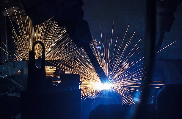 istock Welding robots movement in a car factory 591852518