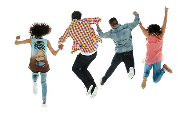 istock Rear view of four friends jumping 591852860
