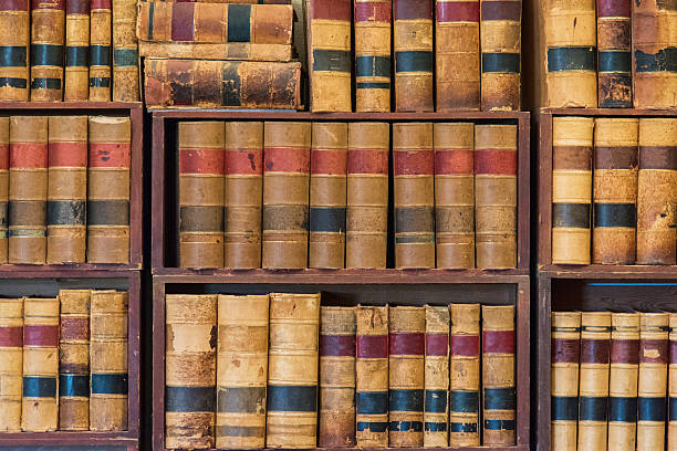 Old Generic Library Background Full frame view of generic old books arranged on shelves in a library. law library stock pictures, royalty-free photos & images
