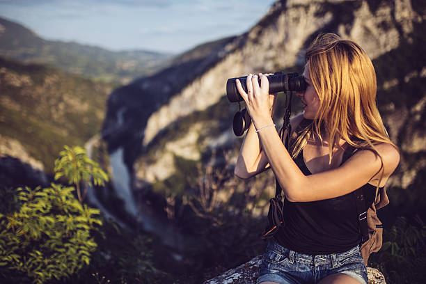 istock Pretty girl with binoculars 591988230