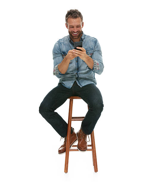 Smiling man using phone Smiling man using phonehttp://www.twodozendesign.info/i/1.png double denim stock pictures, royalty-free photos & images