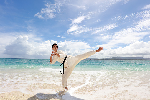 One karate kata training man at the beach