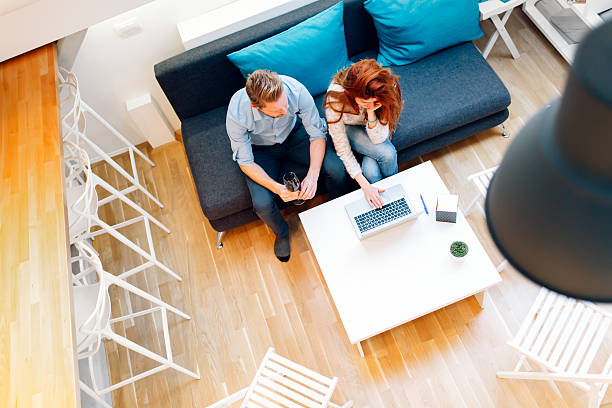 istock Couple working together in beautiful living room 591991488