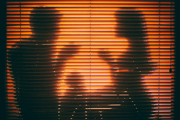 istock Pairs drinking coffee, shadows, orange shutters 591991492