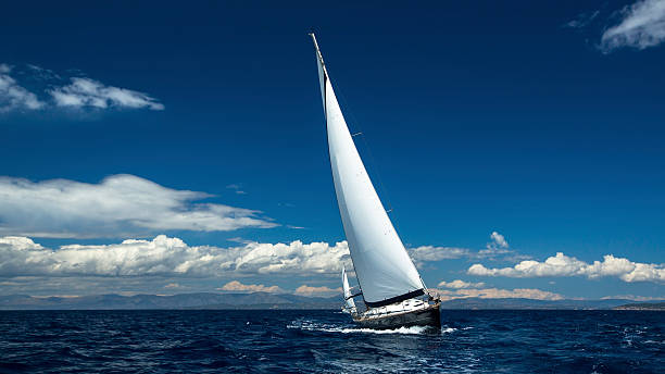 istock Sailing ships yachts with white sails in the open sea. 591991758