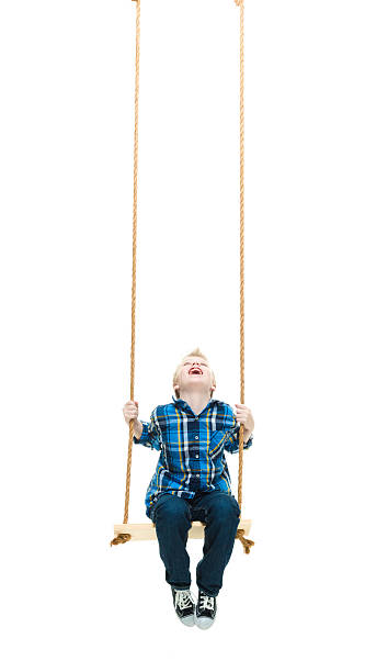 istock Smiling little boy swinging 591991986