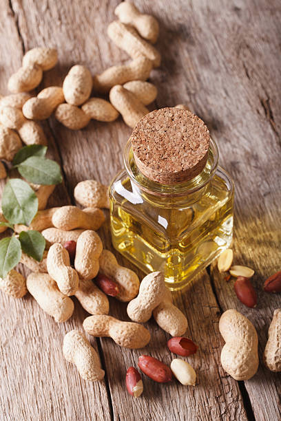 istock Natural peanut oil in a glass jar close up. vertical 591992910