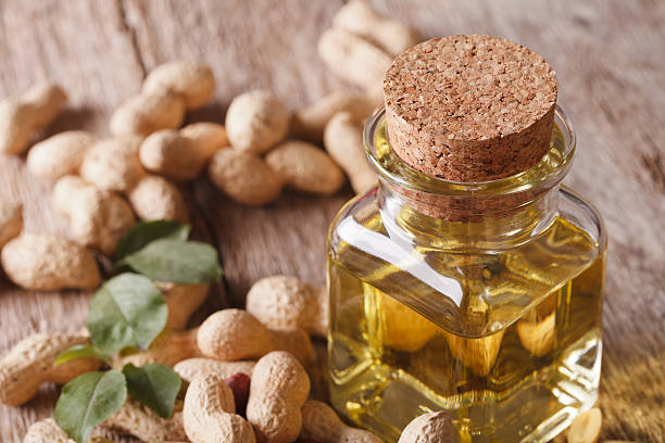 istock peanut oil in a glass bottle on table macro. horizontal 591993054
