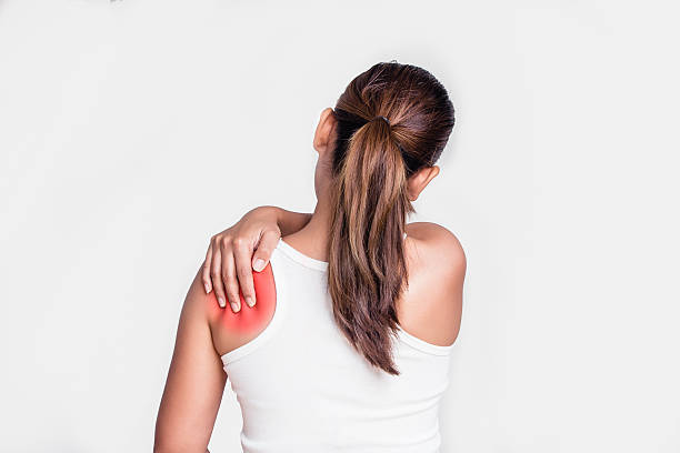 Asian woman with shoulder pain Asian woman with shoulder pain chiropractic adjustment photos stock pictures, royalty-free photos & images