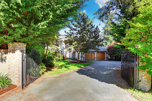 istock View of driveway with opened gate. Double garage 591994122