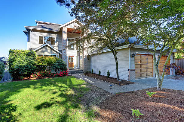istock Luxury house exterior with double garage and well kept garden 591994376