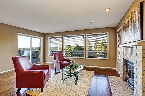 istock Cozy living room interior with fireplace and two red armchairs 591995746