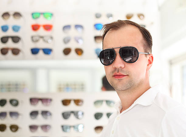 istock Man trying on new sunglasses 591996932