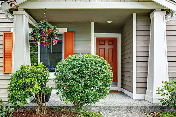 istock Front red entry door exterior. House with siding trim 591997912