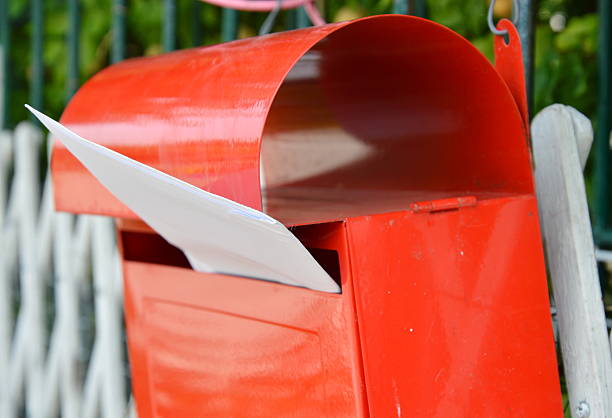 istock letter in red post box on home fence 591998188