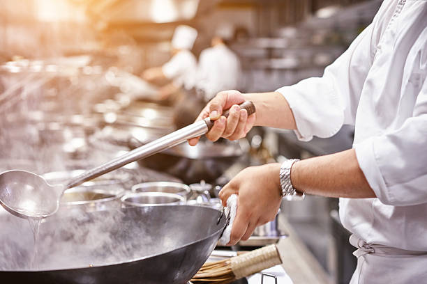 istock Chef in restaurant kitchen at stove with pan 591998886